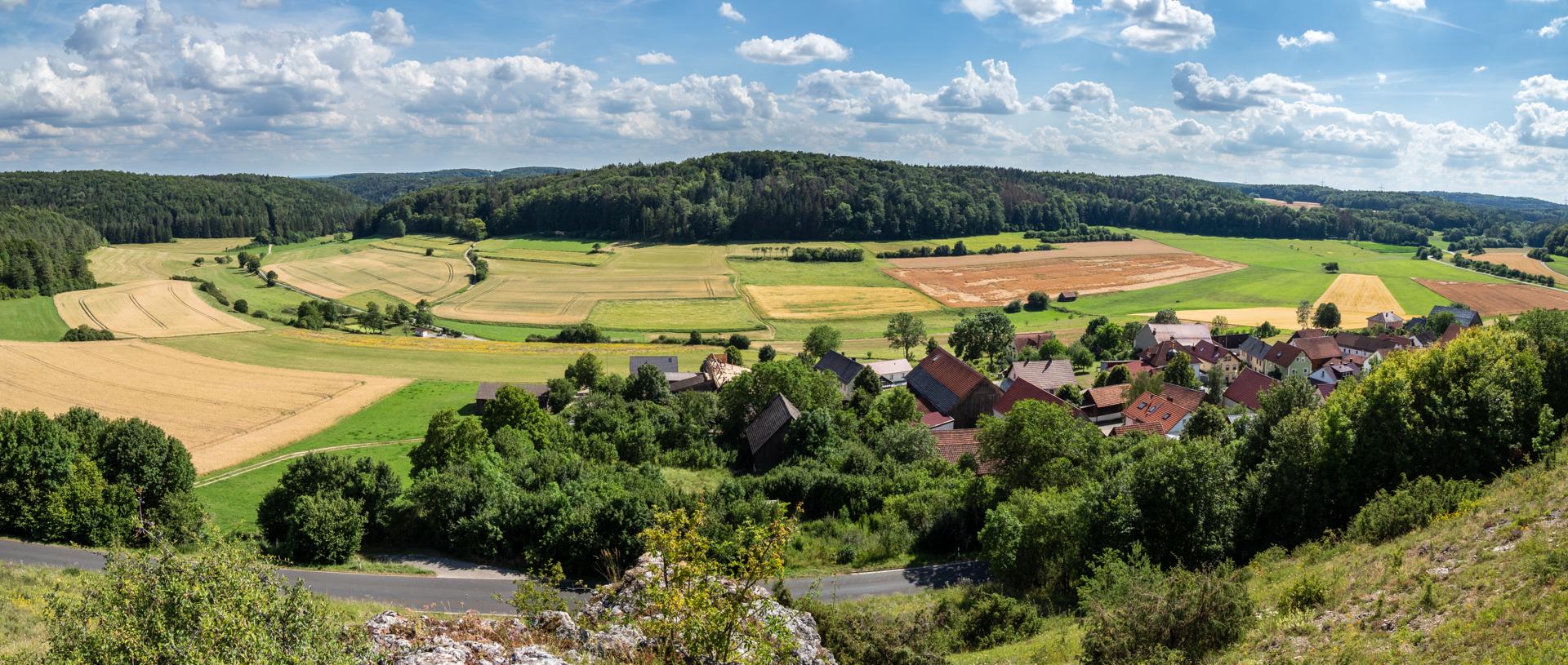 Limestone crags and lush valleys of Franconian Switzerland near Köttel, a hiker's paradise.